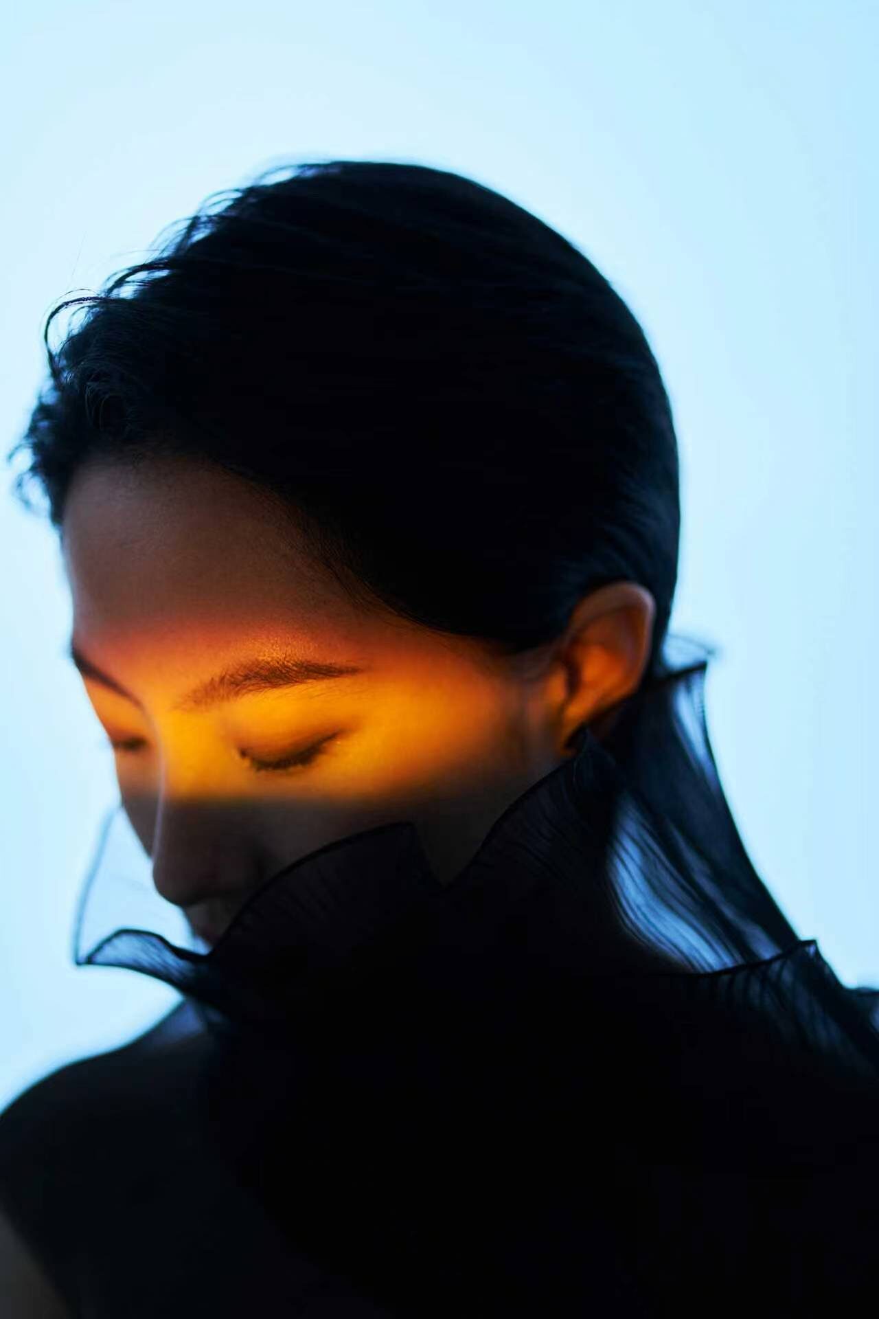 A band of warm light across closed eyes